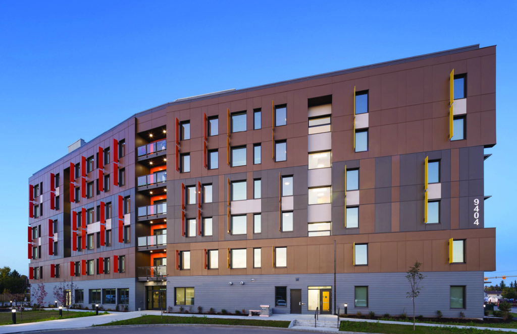 exterior view Fort St. John 50 Unit Passive House - photo of multifamily building at dusk
