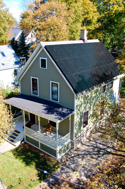Elevated view of older home showing solar panels - photo