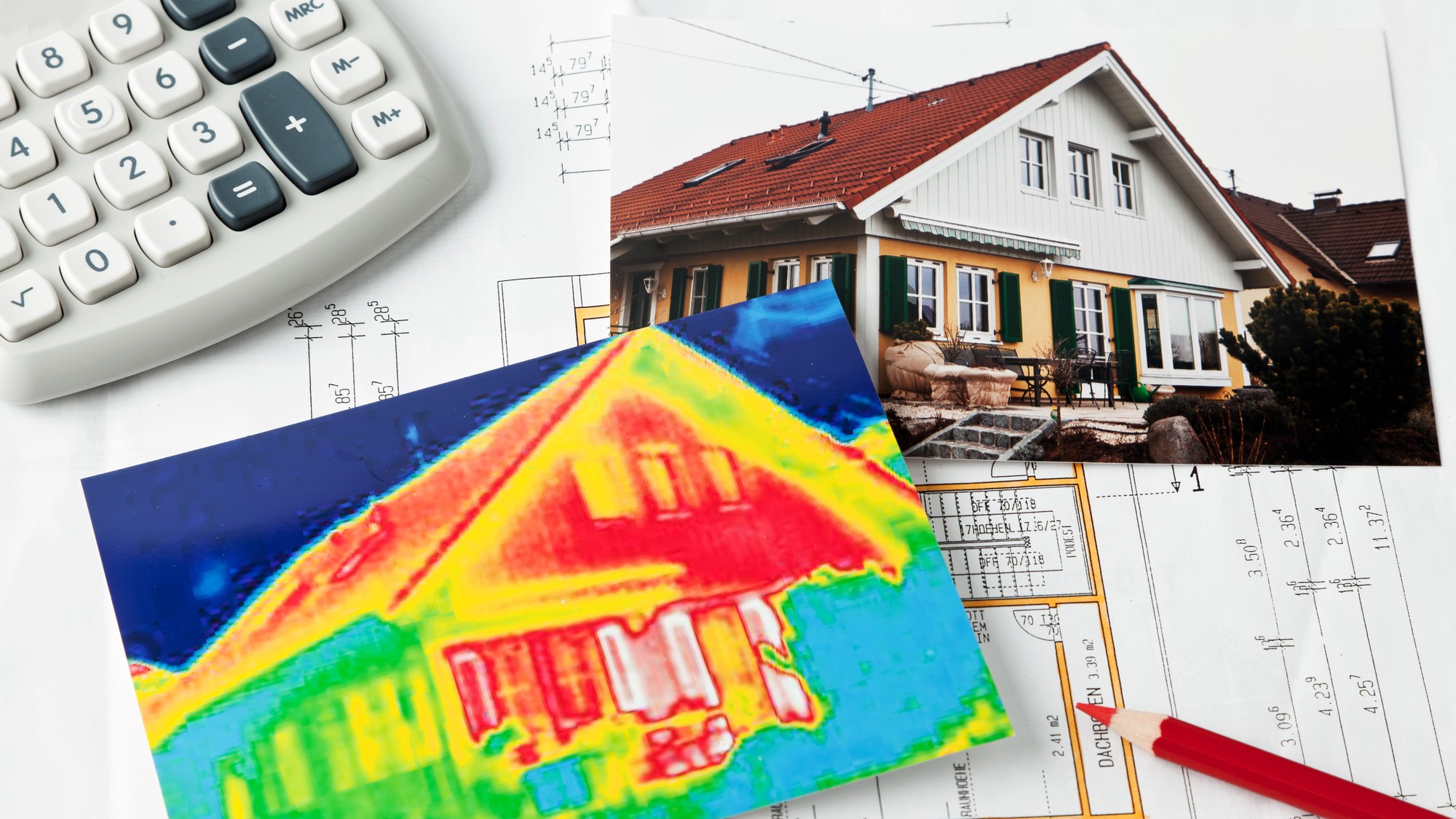 On a surface we see materials used energy audit, including infrared image of home, photo of home, drawings, calculator, pencil - photo