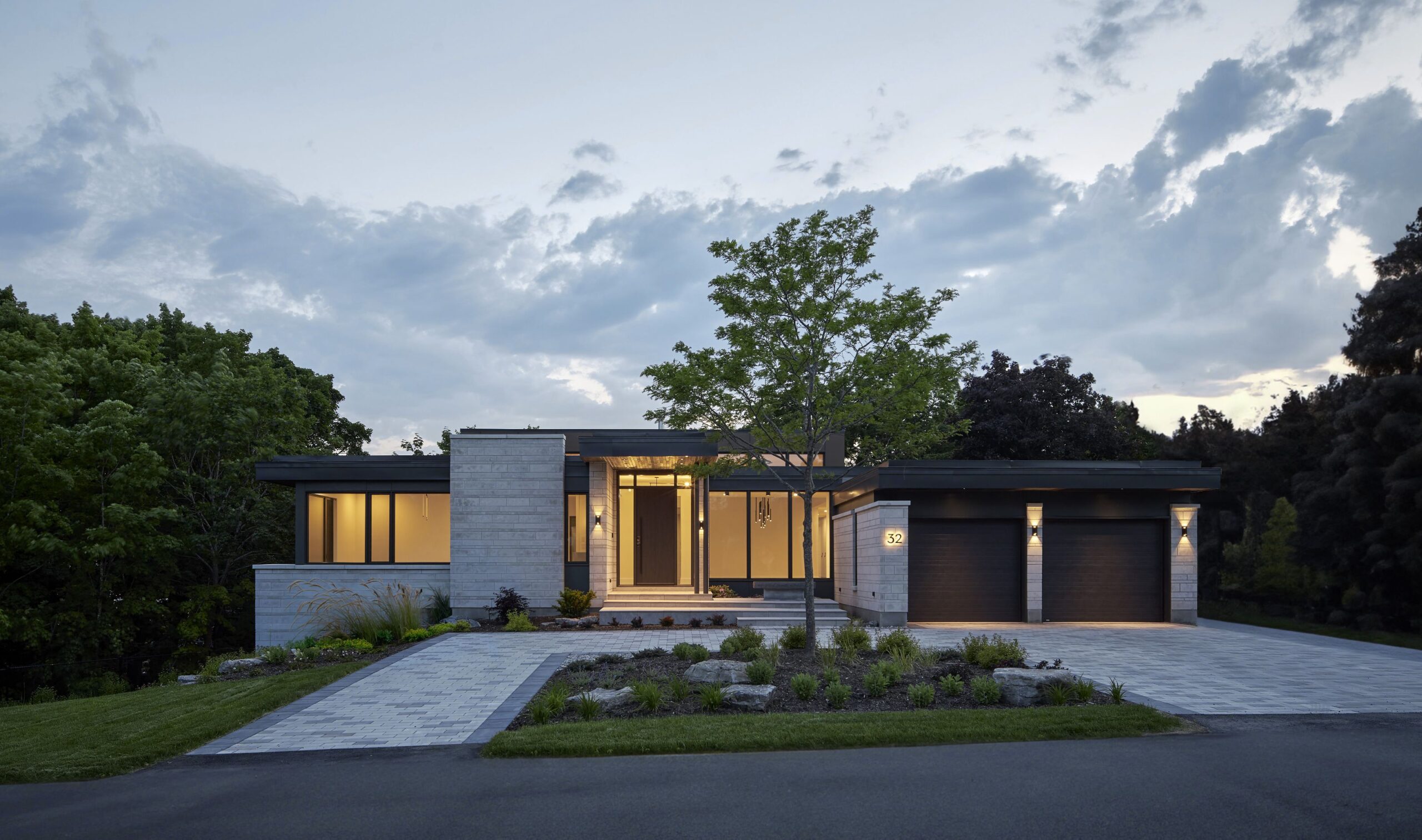 street view of modern net zero home against darkening sky - photo