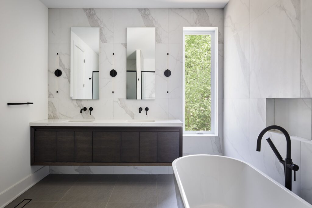 interior view of modern ensuite in net zero home; white marble finishes and modern fixtures - photo