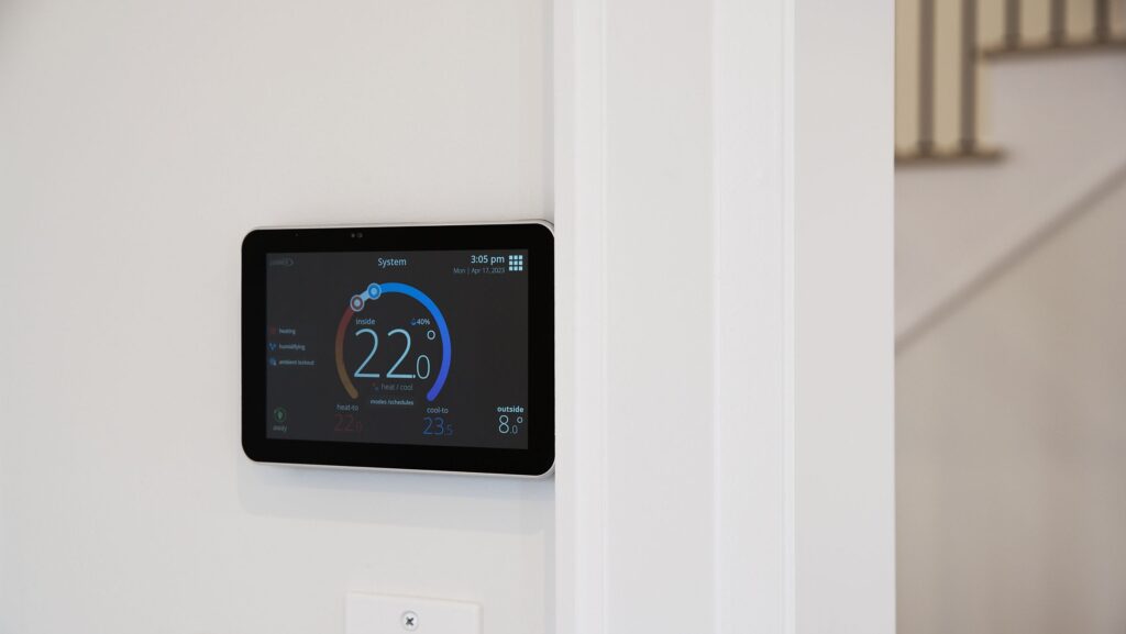 digital climate control panel on the wall of net zero home - photo